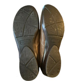 Brown leather shoe soles with visible brand name on a white background
