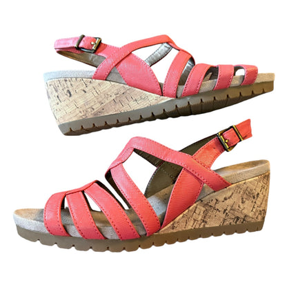 A pair of women's wedge sandals with coral straps and a natural cork wedge heel, shown from two angles on a white background.
