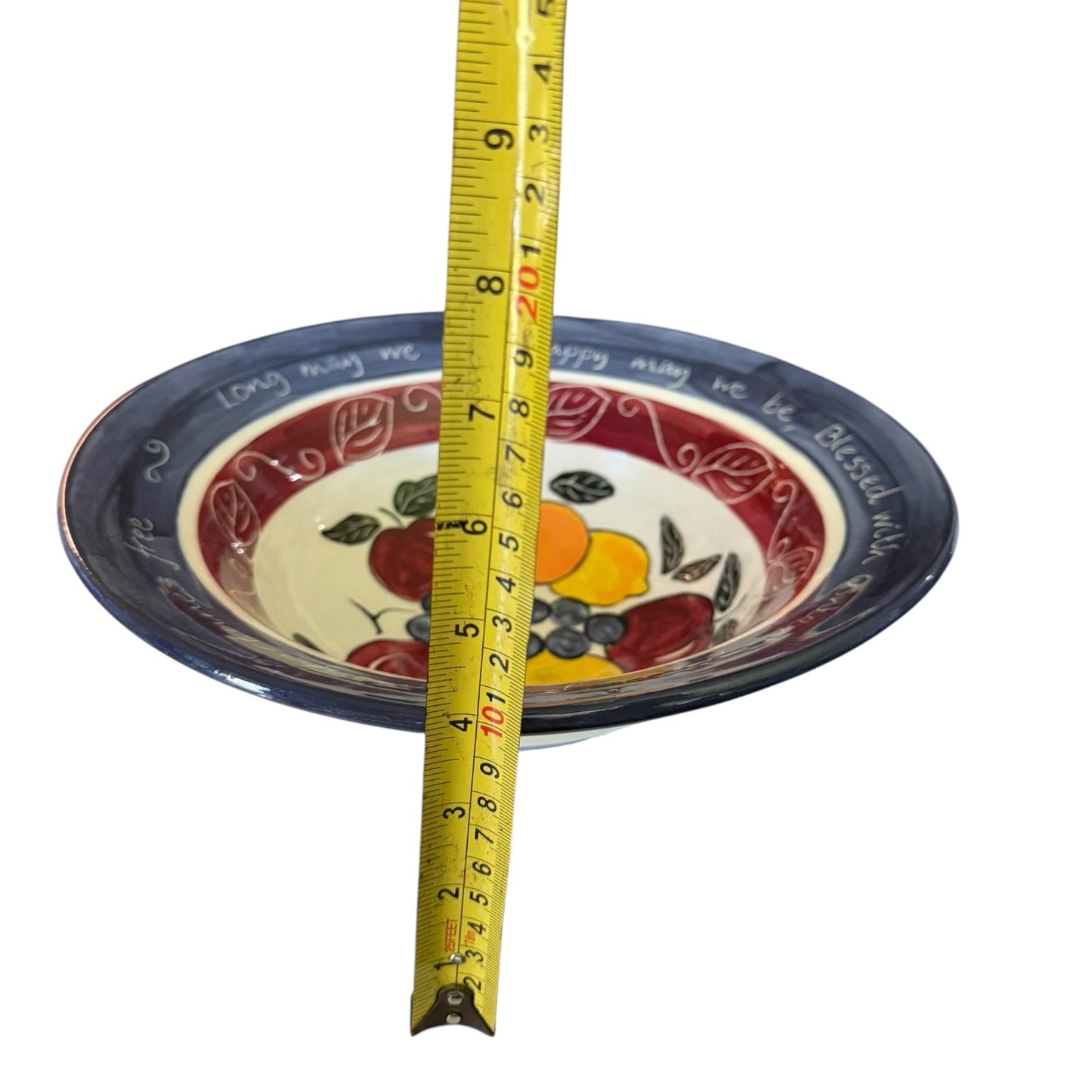 Decorative plate with a measuring tape for size reference on a white background