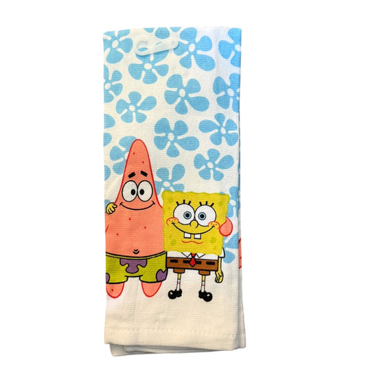 A folded white kitchen towel featuring a blue floral pattern and cartoon characters SpongeBob SquarePants and Patrick Star.