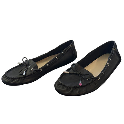 Front side of a Pair of black loafers on a white background