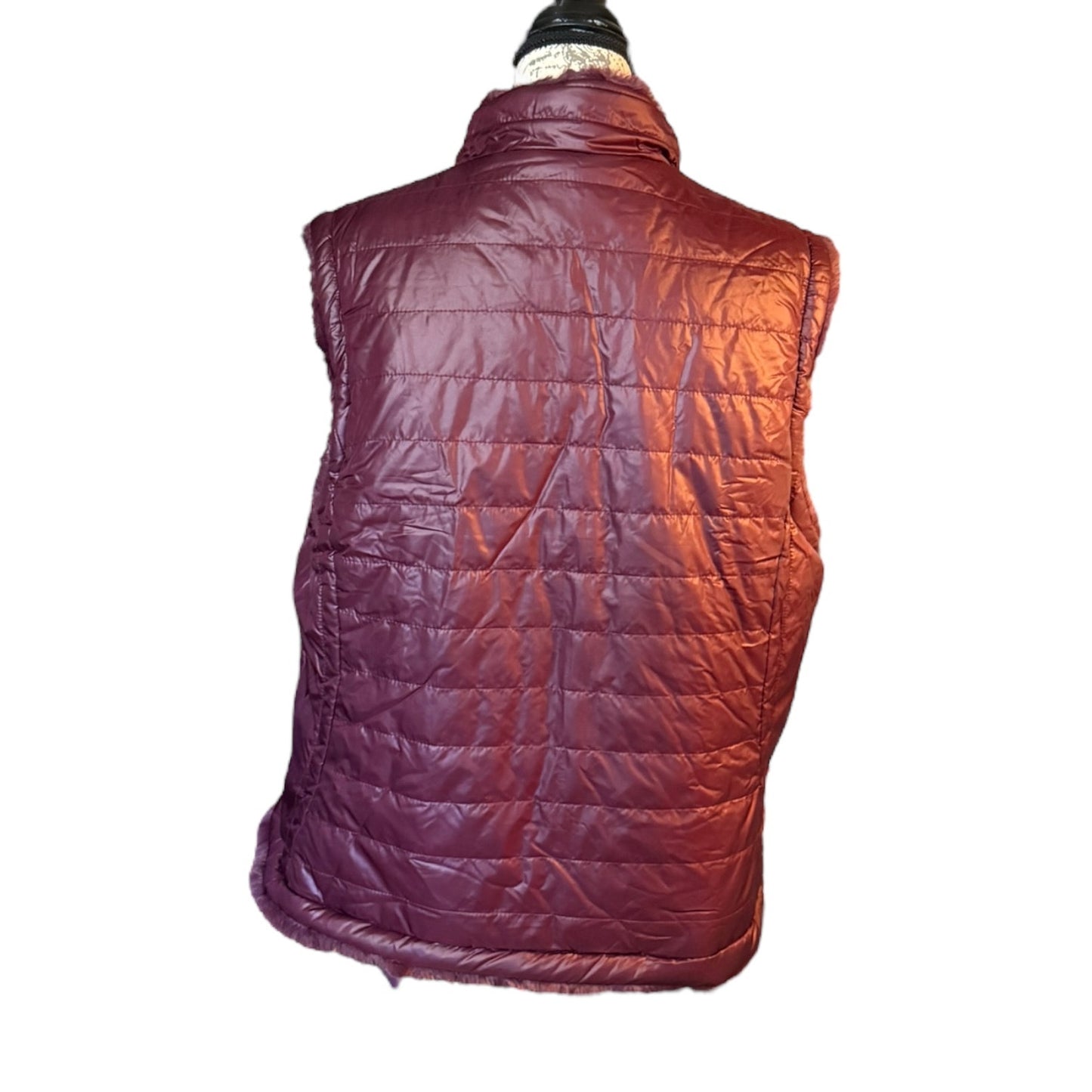 Back of  puffer vest on a mannequin against a white background