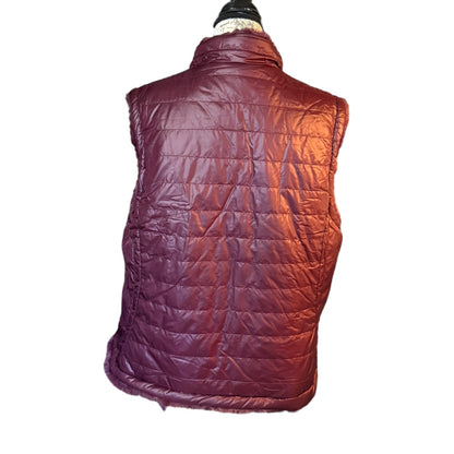 Back of  puffer vest on a mannequin against a white background