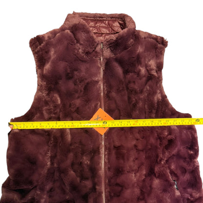 fur vest with a measuring tape across it on a white background
