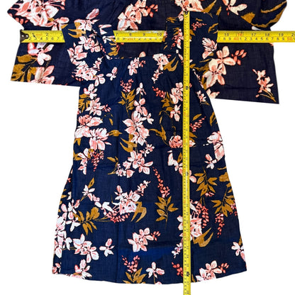 Floral-patterned dress with a measuring tape on a white background