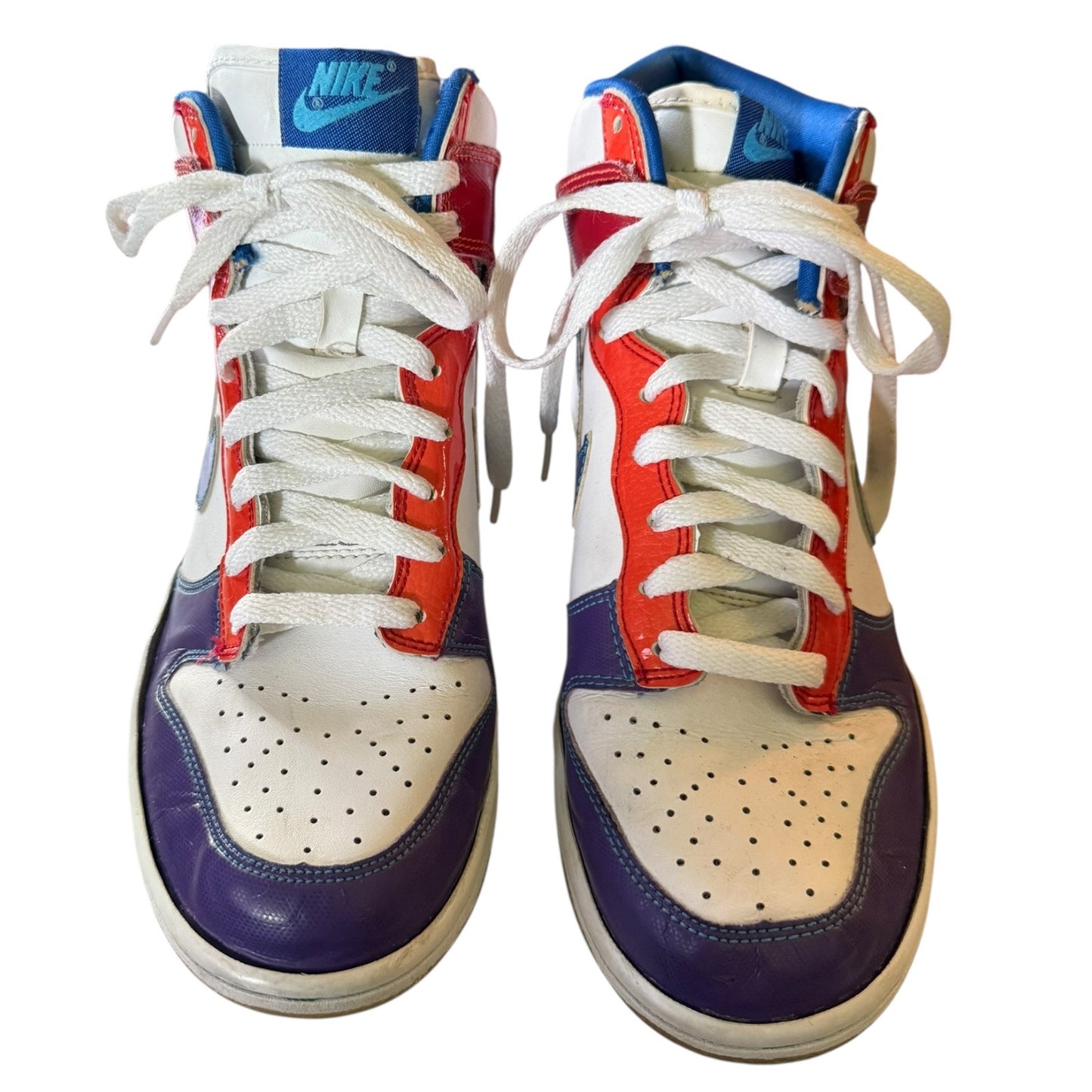 Front of a Pair of Nike sneakers with red, white, and blue design on a white background