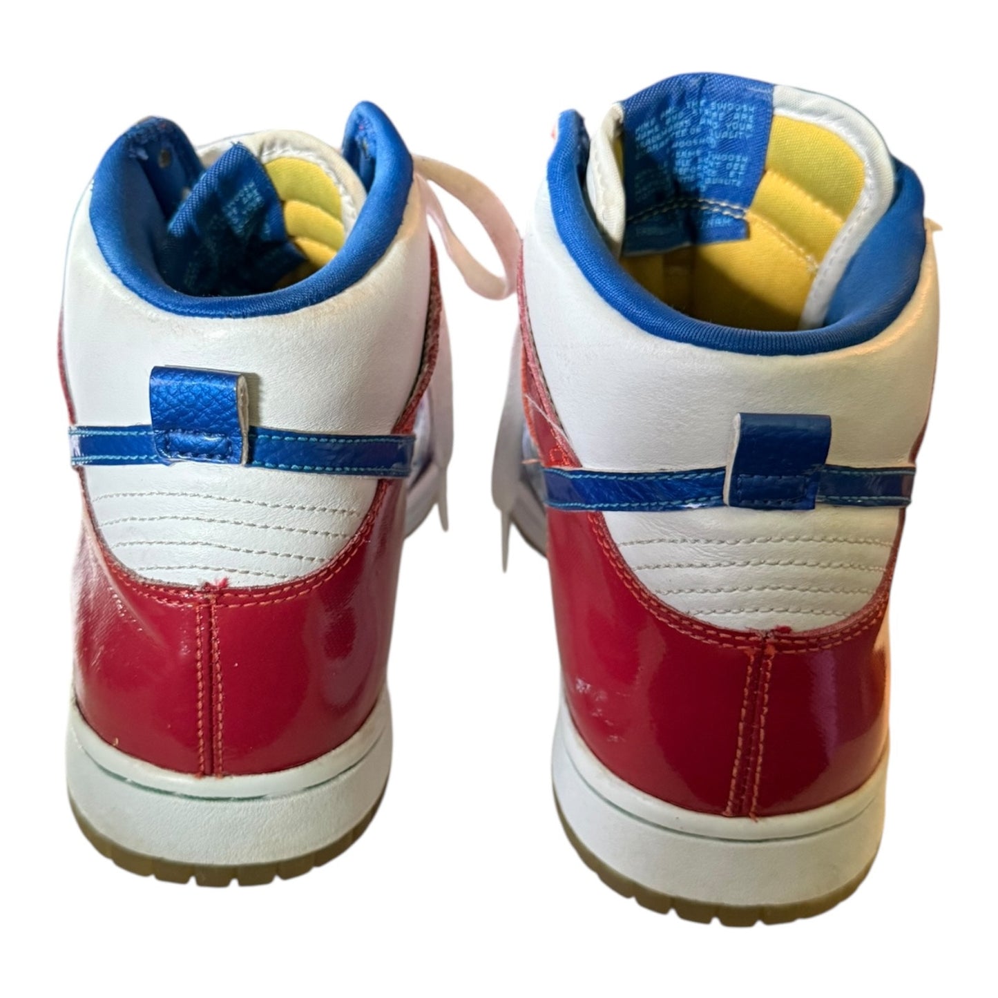 Back of a Pair of red, white, and blue sneakers on a white background