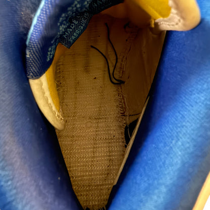 Close-up of interior of shoe sole with visible wear on a blue background