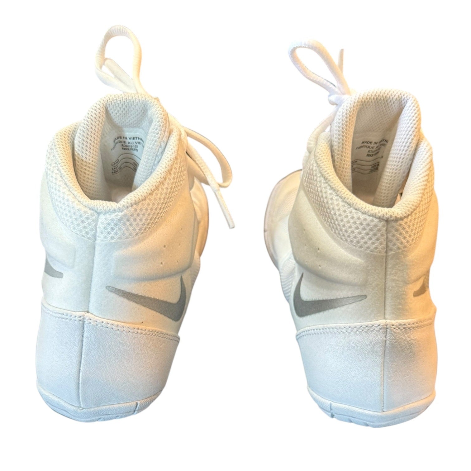 A pair of white Nike high-top wrestling sneakers shown from the back, featuring a white mesh and leather upper with a gray Swoosh logo.