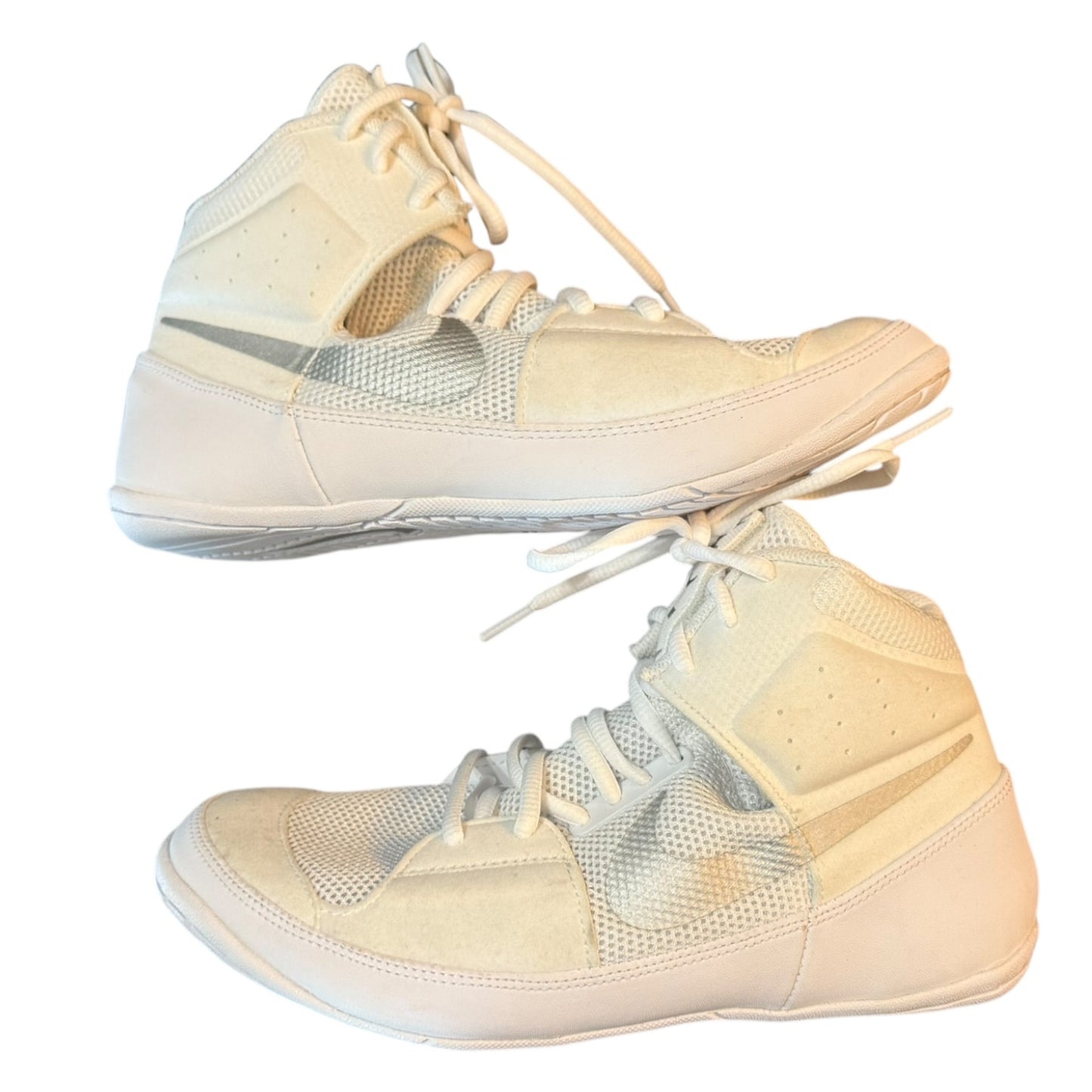 Pair of white high-top sneakers on a white background