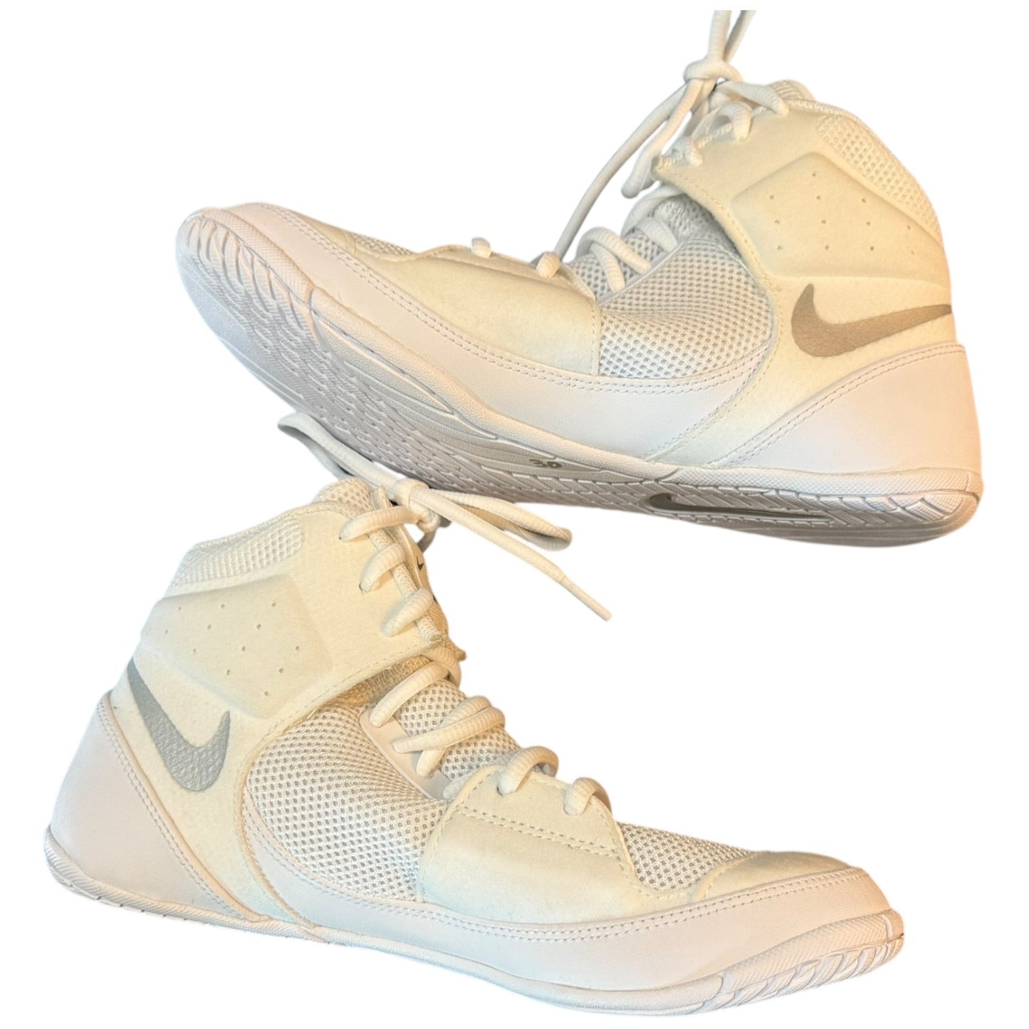 Pair of white Nike sneakers on a white background