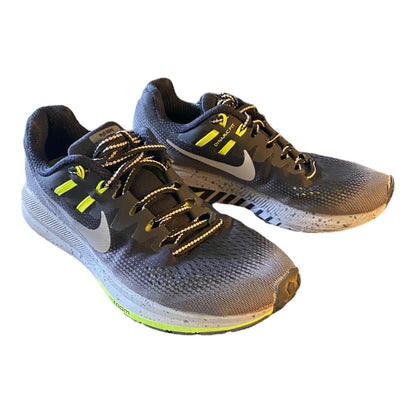 Front side Pair of gray running shoes with yellow accents on a white background
