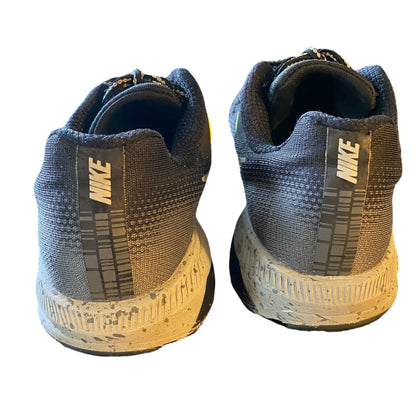 Back of Pair of black and gray Nike sneakers on a white background