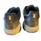 Back of Pair of black and gray Nike sneakers on a white background