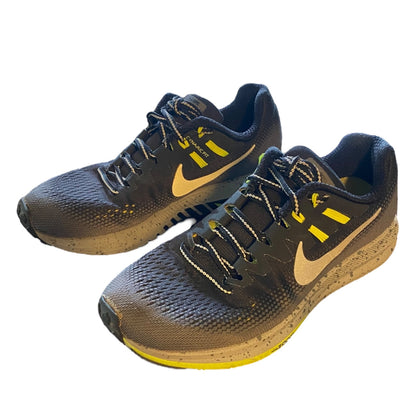 Front side Pair of gray running shoes with yellow accents on a white background