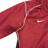 Red athletic shirt with Nike logo on a white background