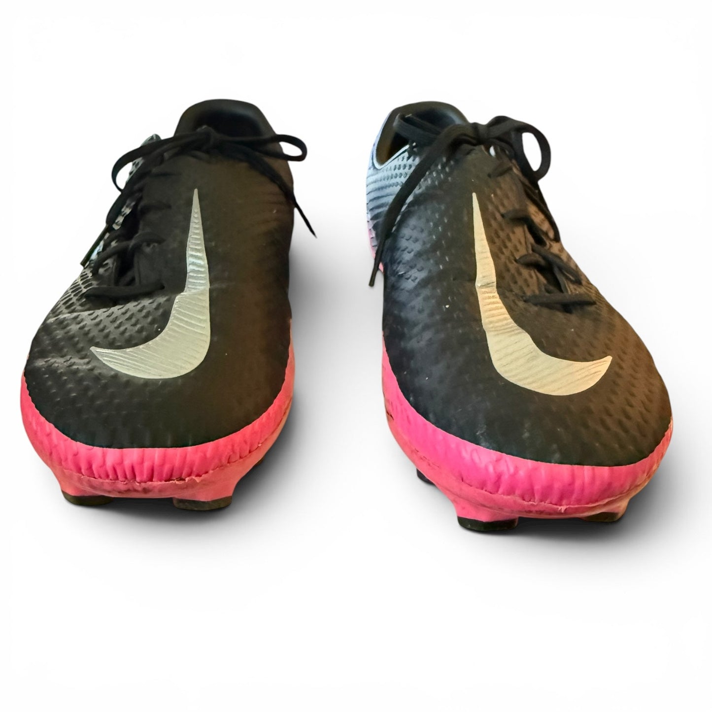 Black and pink soccer cleats with Nike logo on a white background