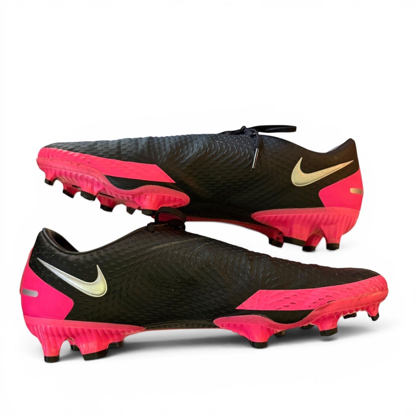 Black and pink soccer cleats with Nike logo on a white background