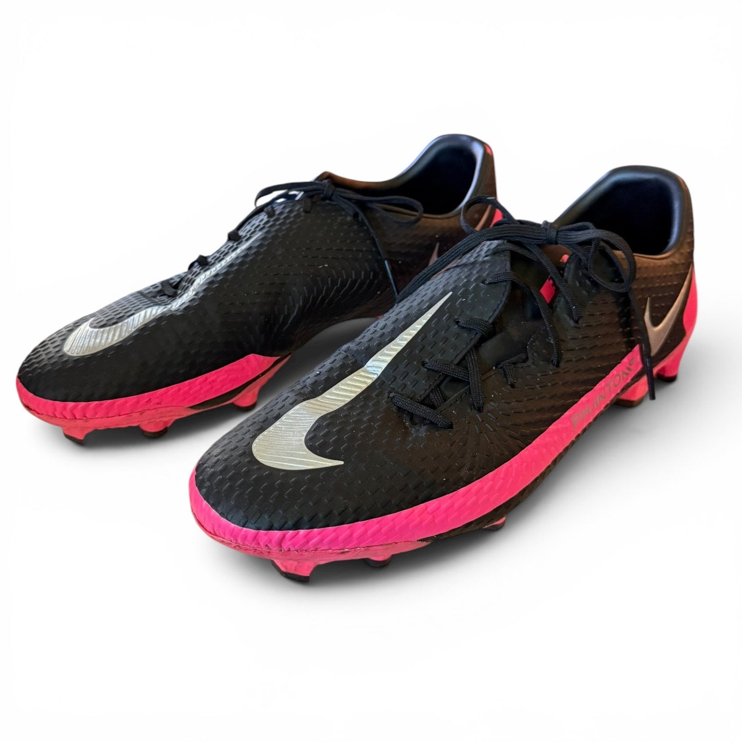 Black and pink soccer cleats with Nike logo on a white background