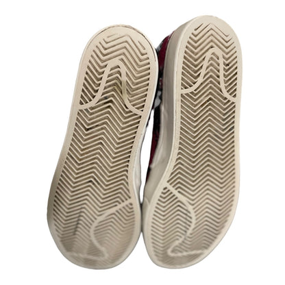 Close-up of the soles of a pair of shoes on a white background