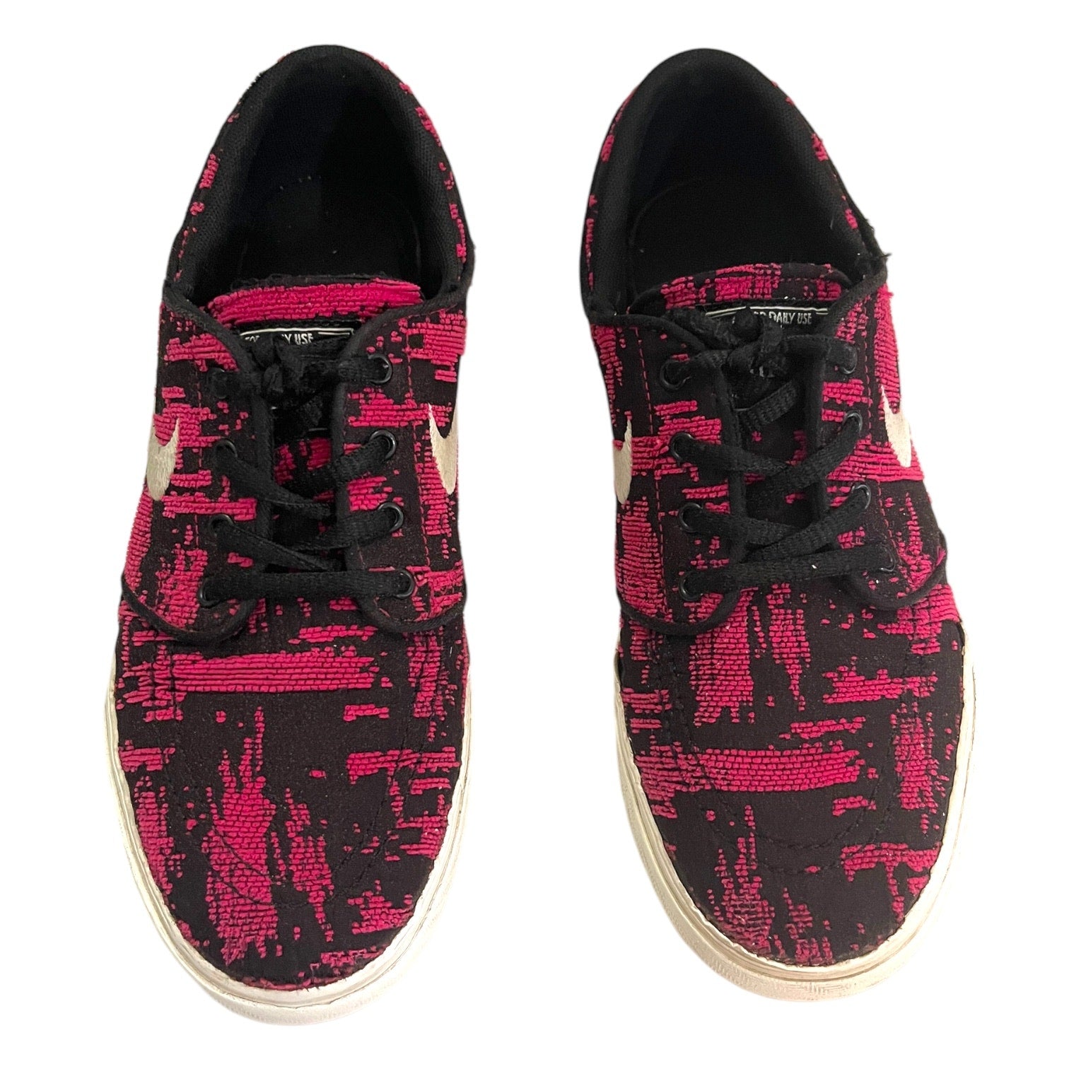 Black and pink patterned sneakers on a white background