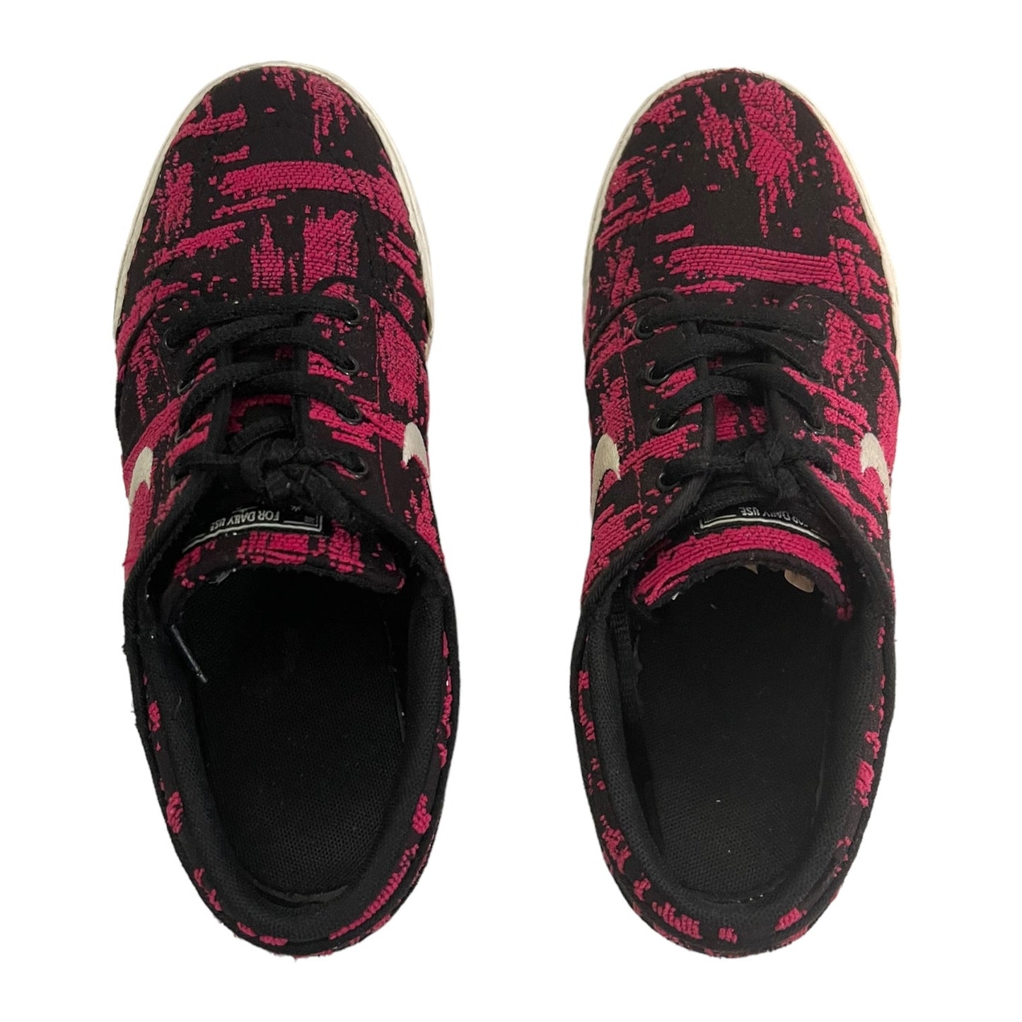 Black and pink patterned sneakers on a white background