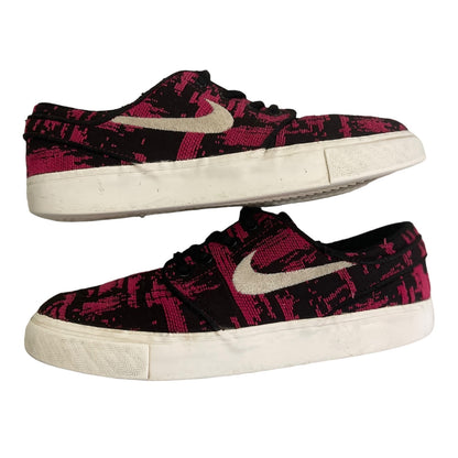 Pair of black and pink patterned sneakers with a white swoosh logo on a white background