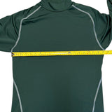Green athletic shirt with a yellow measuring tape across it on a white background