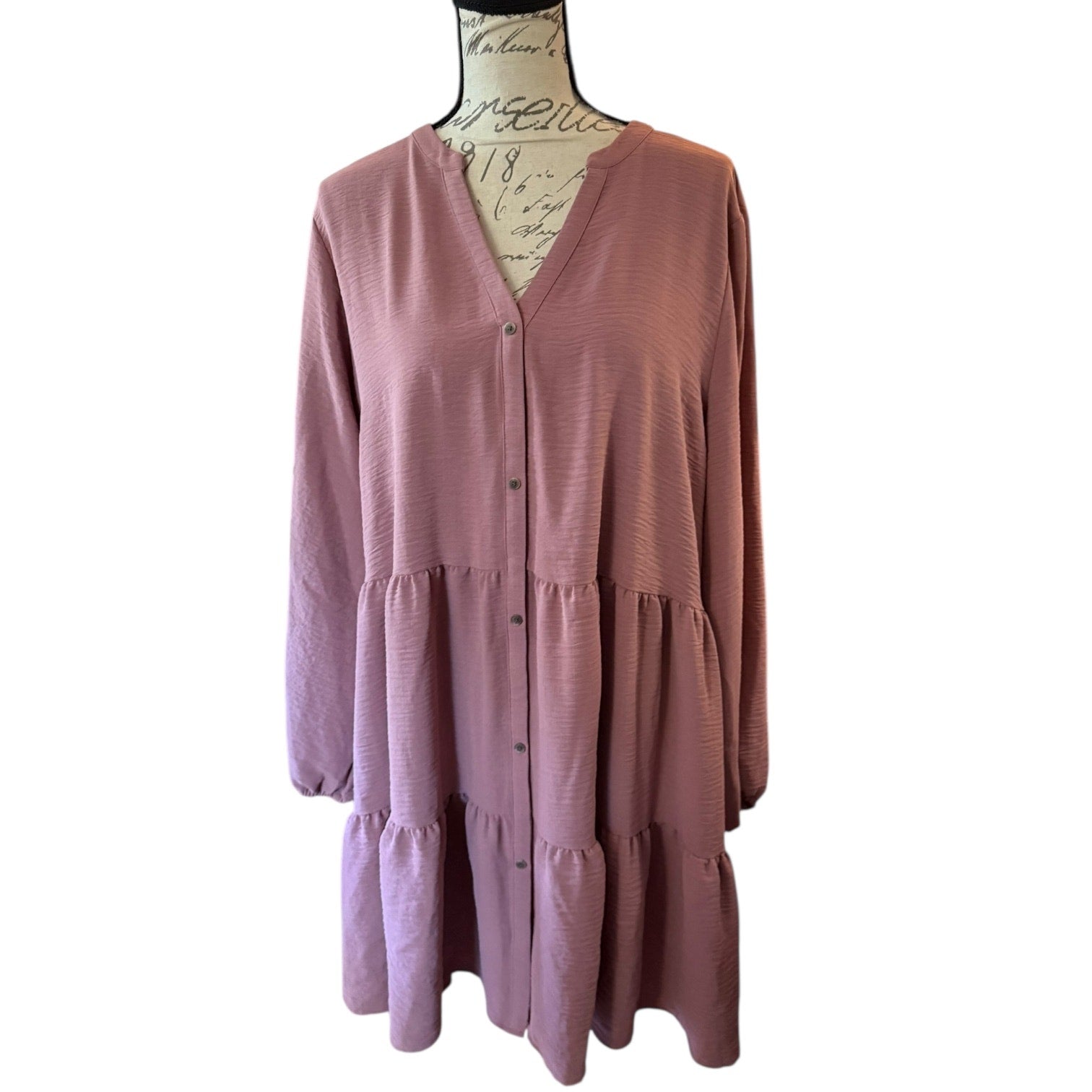 Pink dress on a mannequin against a white background