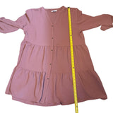 Pink dress with a measuring tape on a white background