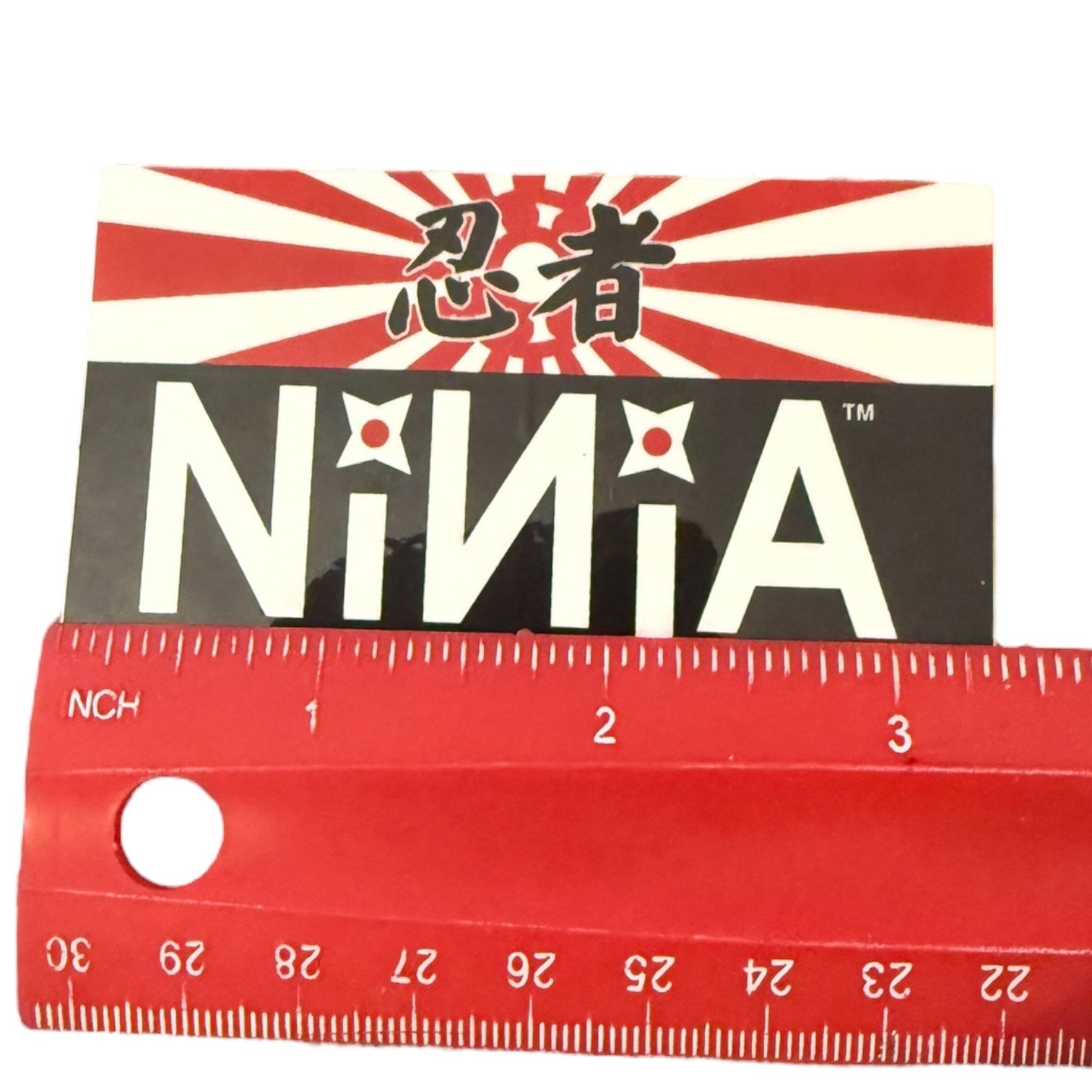 Ninja-themed product with a ruler for scale on a white background