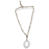Gold chain necklace with a pearl pendant on a white background