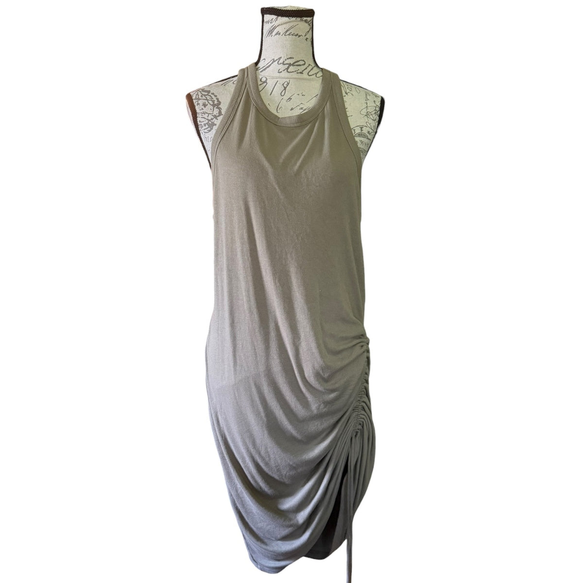 A sleeveless draped tank dress in a light green color, displayed on a vintage-style dress form mannequin against a plain white background.