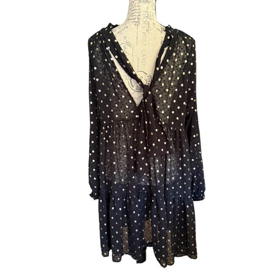 Black polka dot dress on a mannequin against a white background