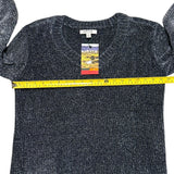 Navy sweater with a brand tag and measuring tape on a white background