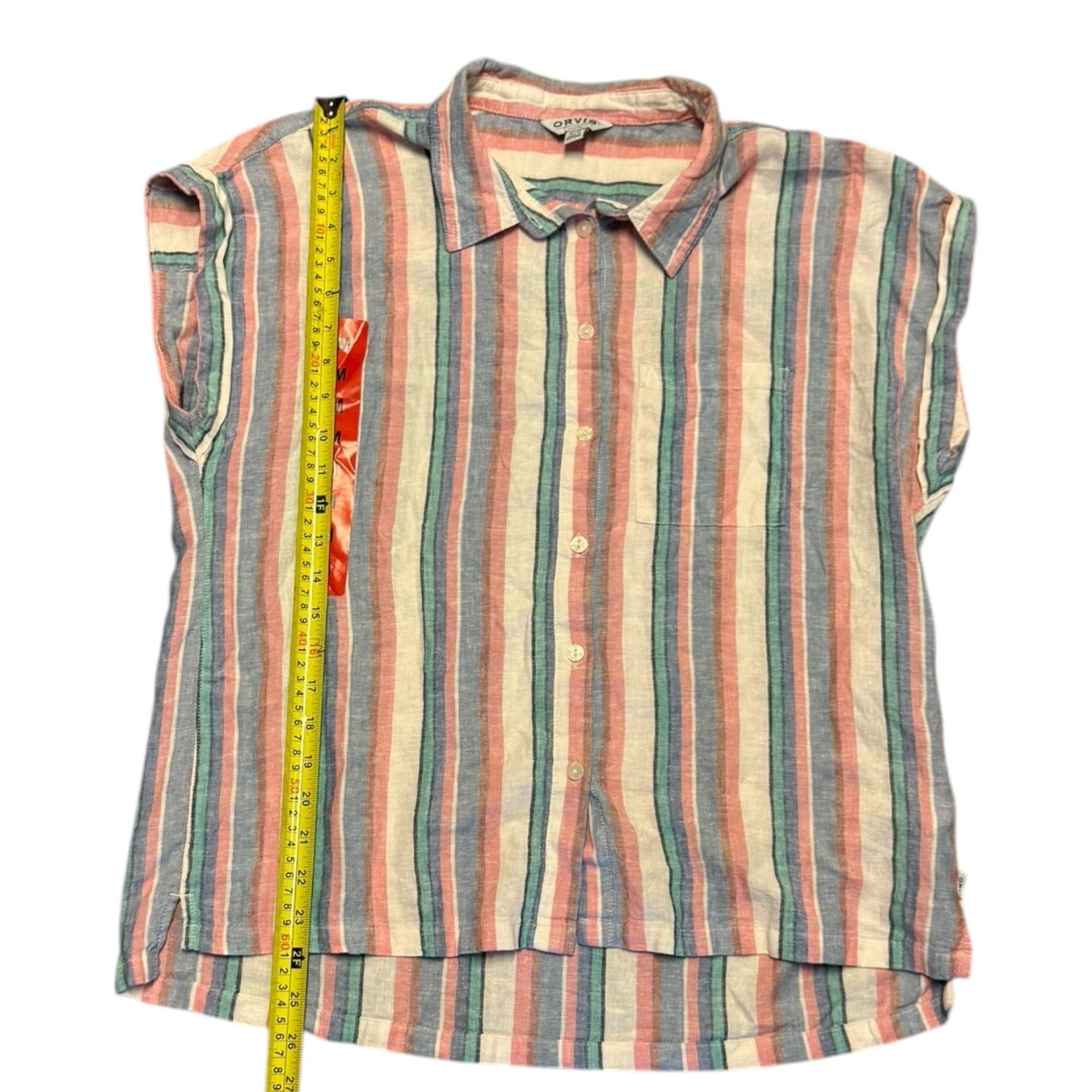 A striped short-sleeve button-up shirt laid flat on a white background, with a yellow measuring tape vertically positioned along the left side to indicate size. 