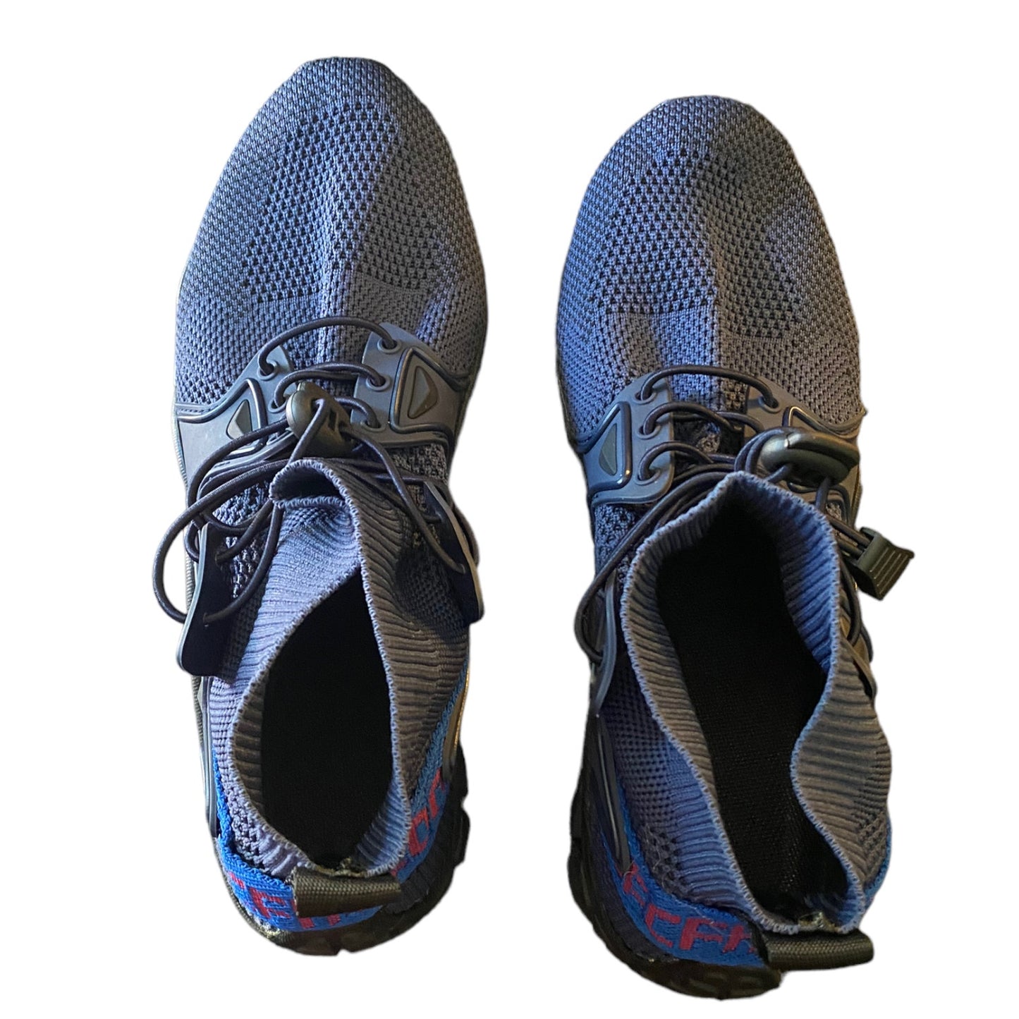 Top of Pair of blue and gray athletic shoes on a white background