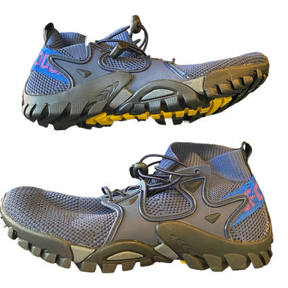 Side of blue athletic shoes with yellow sole on a white background