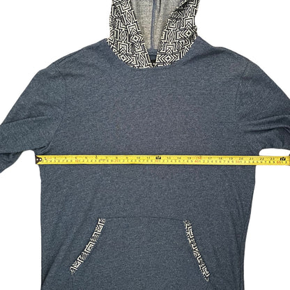 Blue hoodie with patterned hood and pockets, measured with a yellow tape measure.