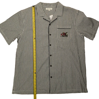 Gray and white striped shirt with a pocket and logo, measured by a tape measure on a white background.