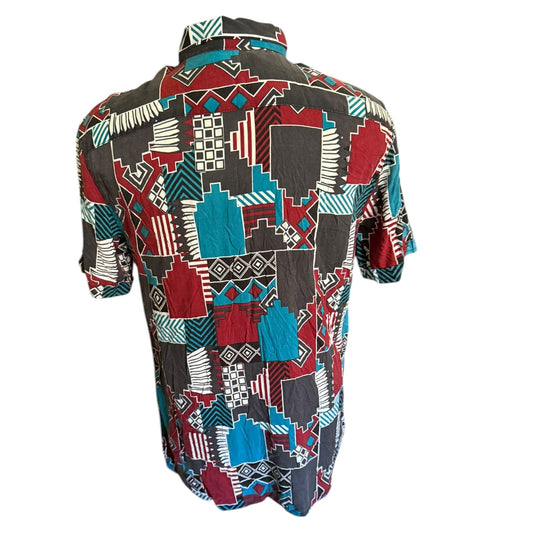 Colorful geometric patterned shirt on a white background