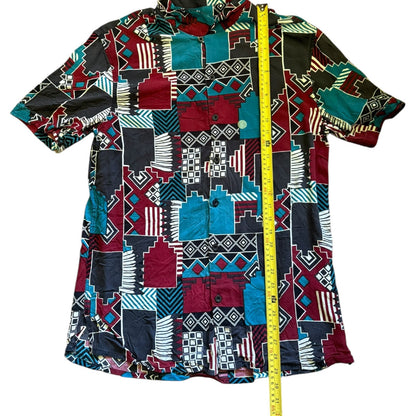 Colorful patterned shirt with a measuring tape for size reference on a white background