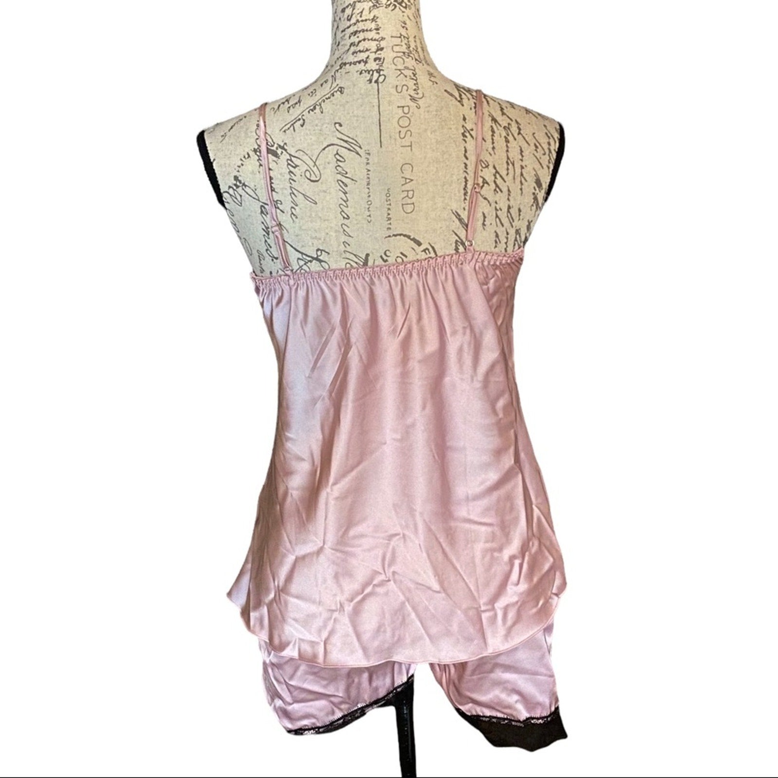 Light pink pajamas on a mannequin with a decorative background