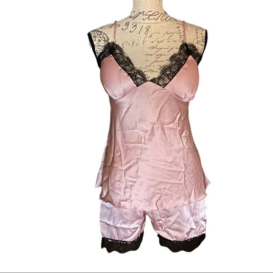 Pink satin pajamas with lace trim on a mannequin against a white background