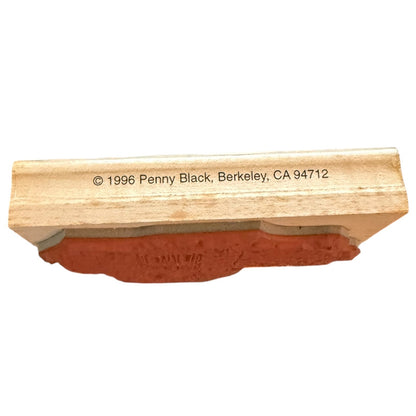 A wooden rubber stamp block with a terracotta-colored rubber face, featuring printed copyright text reading '© 1996 Penny Black, Berkeley, CA 94712' on the wooden block.