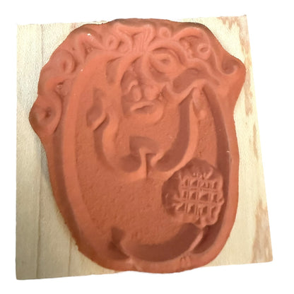 Rubber stamp with a decorative design on a white background