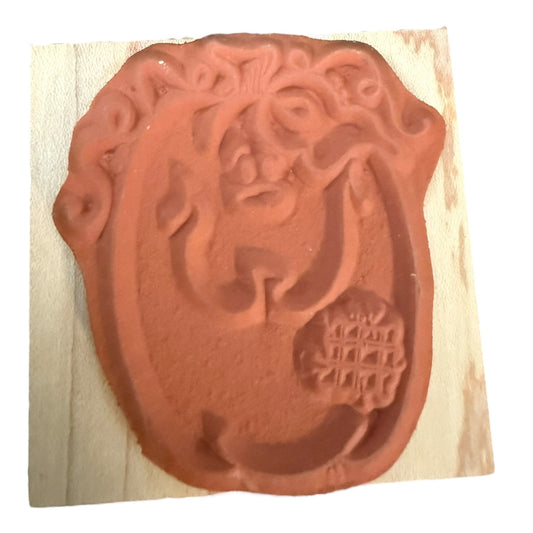 Rubber stamp with a decorative design on a white background