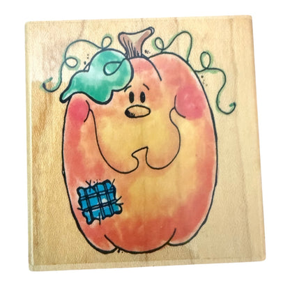 Wooden block with a cartoon pumpkin design on a white background