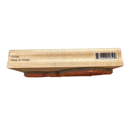 A wooden hanging hedge tool or block with a barcode label and the text '4059K hang on hedge' printed on the side, shown against a plain white background.