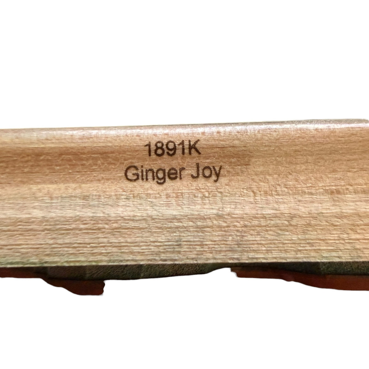 Wooden product with '1891K Ginger Joy' engraving on a white background